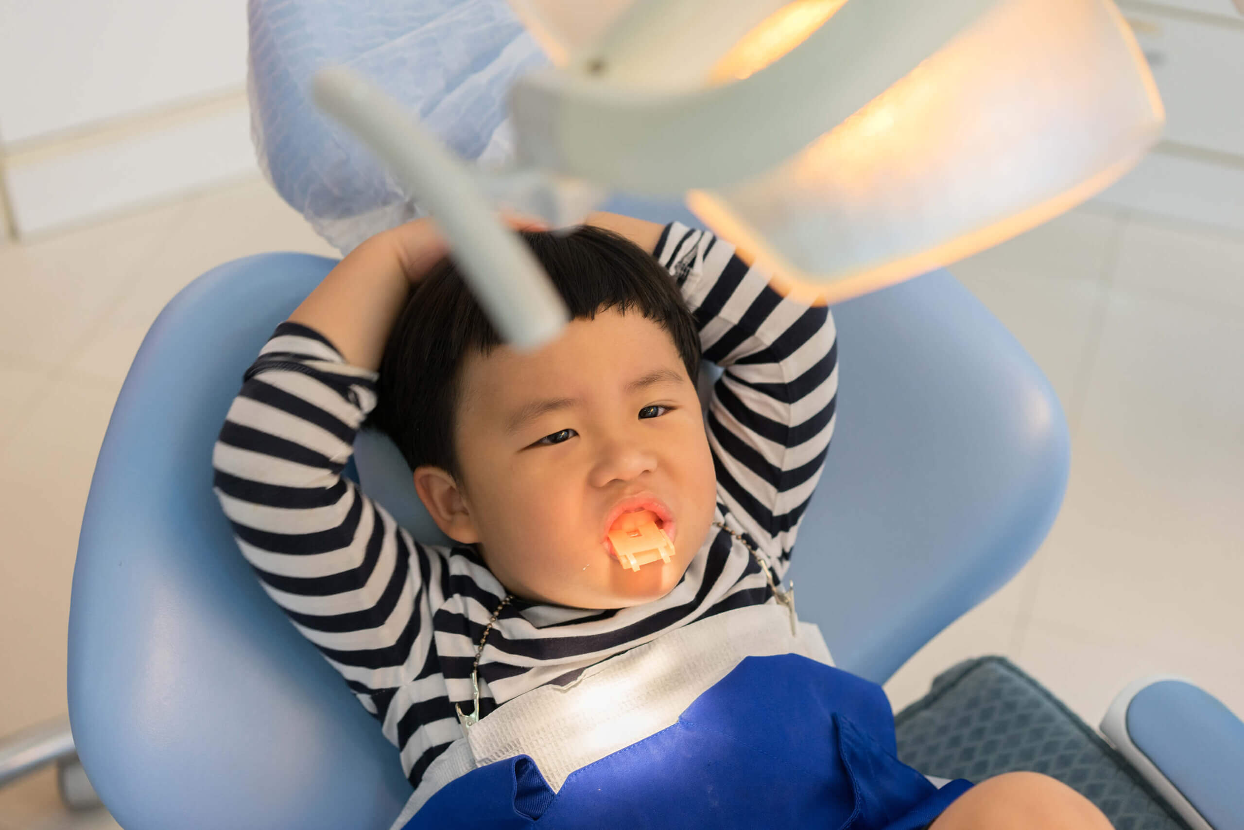 Child taking flouride treatment at Aquila Dental