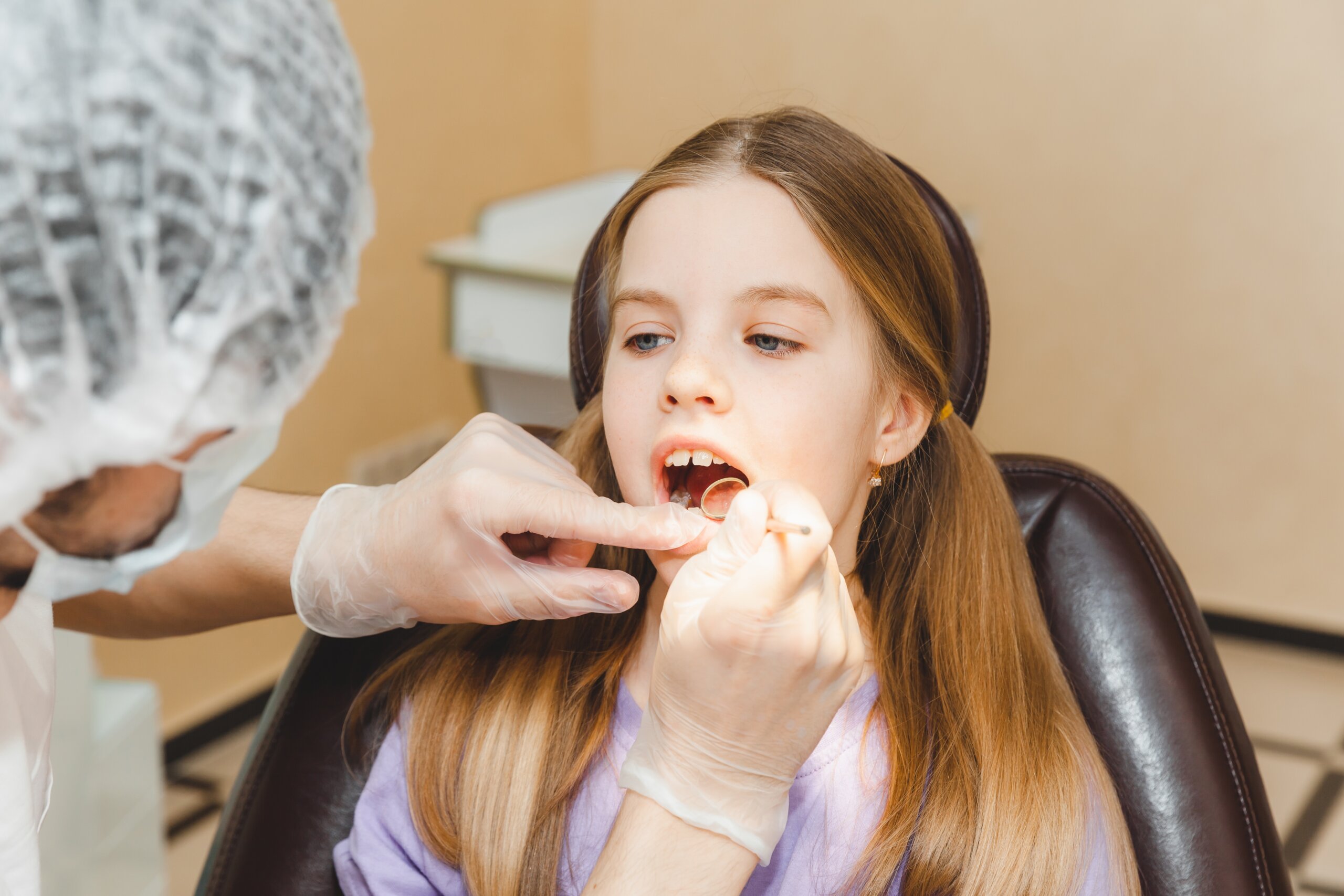 Doctor examine girl regarding dental fillings at Aquila Dental AZ